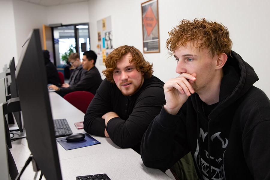 两名火博体育的学生坐在电脑前