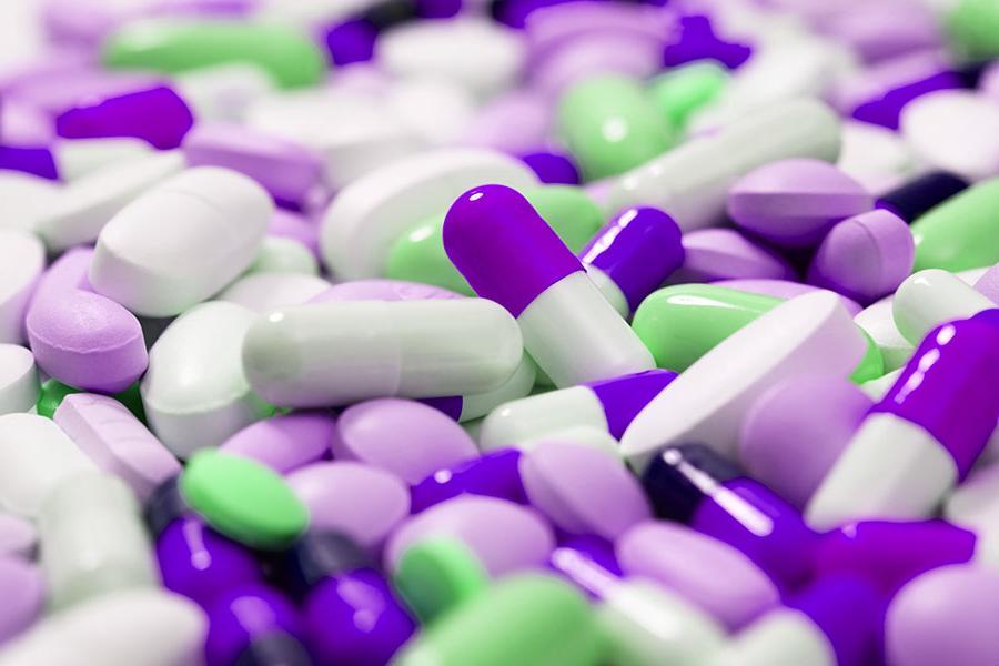 紫色、白色和绿色药丸的特写图像